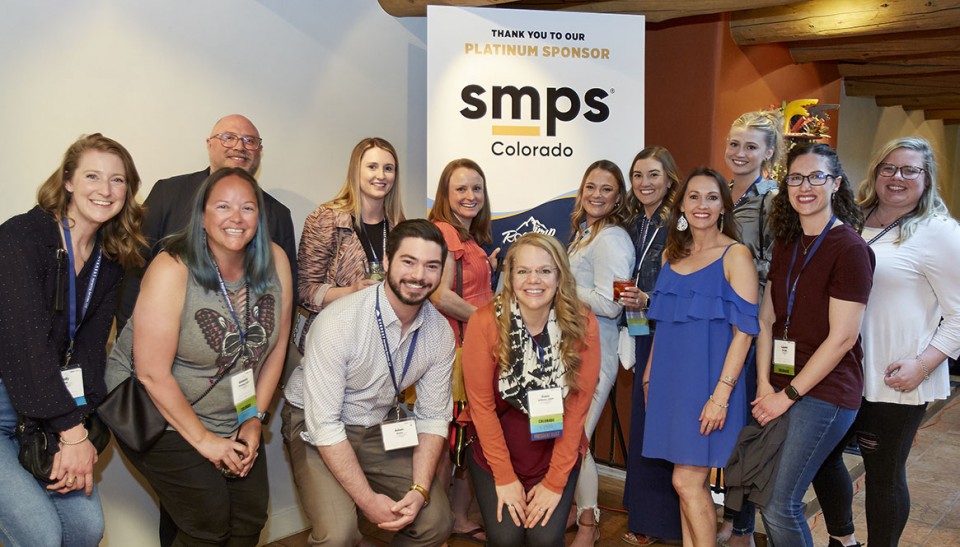 Colorado SMPS members posing in front of banner at regional conference
